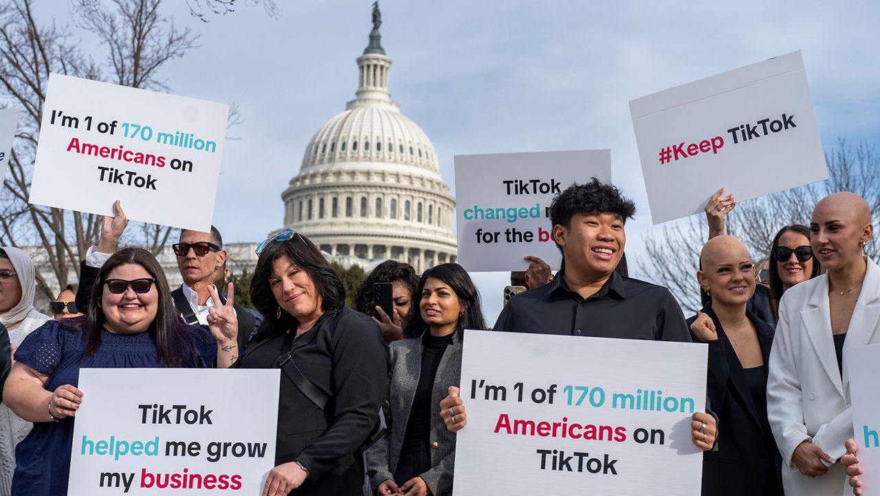 Devotees of TikTok cheer their support to passing motorists at the Capitol in Washington, before the House passed a bill that would lead to a nationwide ban of the popular video app if its China-based owner doesn't sell, Wednesday, March 13, 2024. (AP Photo/J. Scott Applewhite)