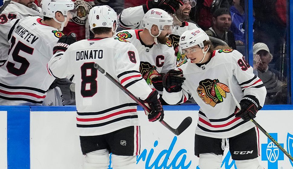 Chicago Blackhawks center Connor Bedard (98) celebrates his goal against the Tampa Bay Lightning with center Ryan Donato (8) during the second period of an NHL hockey game Tuesday, Jan. 28, 2025, in Tampa, Fla. (AP Photo/Chris O'Meara)