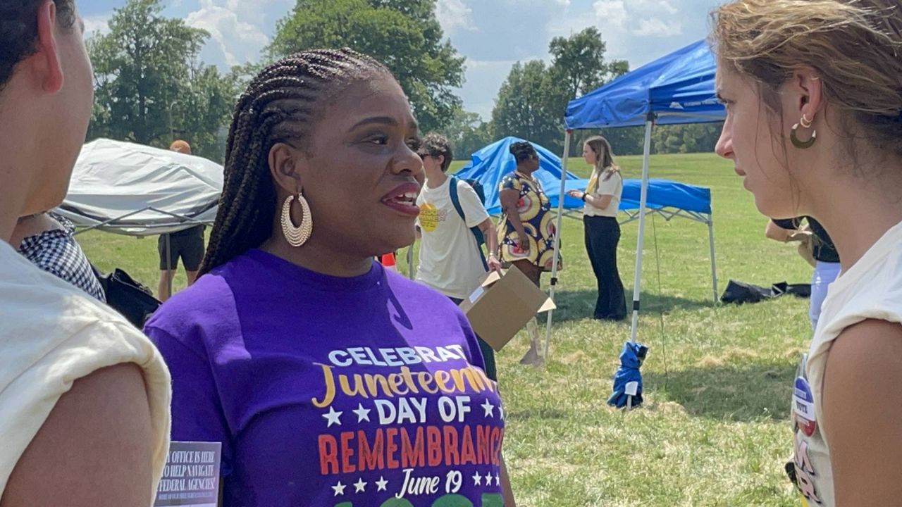 Rep. Cori Bush, D-Mo., talks to attendees at a Juneteenth celebration in Fairground Park in St. Louis, Mo. on June 19, 2024. (Spectrum News/Gregg Palermo)