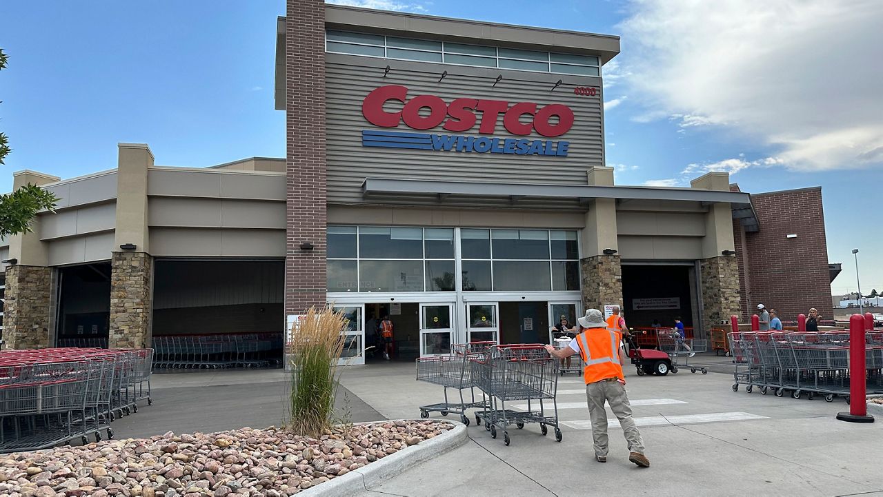 A cart wrangler works in front of a Costco warehouse on July 16, 2024, in Sheridan, Colo. (AP Photo/David Zalubowski)