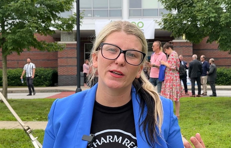 Courtney Gary-Allen, organizing director of the Maine Recovery Advocacy Project, talks about her efforts to open harm reduction centers across Maine during Thursday's opioid summit in Auburn. (Spectrum News/Susan Cover)