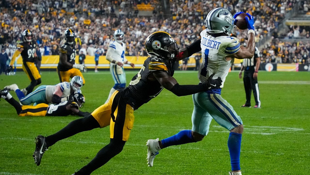 Dallas Cowboys wide receiver Jalen Tolbert (1) makes a touchdown catch as Pittsburgh Steelers safety DeShon Elliott tries to stop him during the second half of an NFL football game, early Monday, Oct. 7, 2024, in Pittsburgh. The Cowboys won 20-17. (AP Photo/Gene J. Puskar)