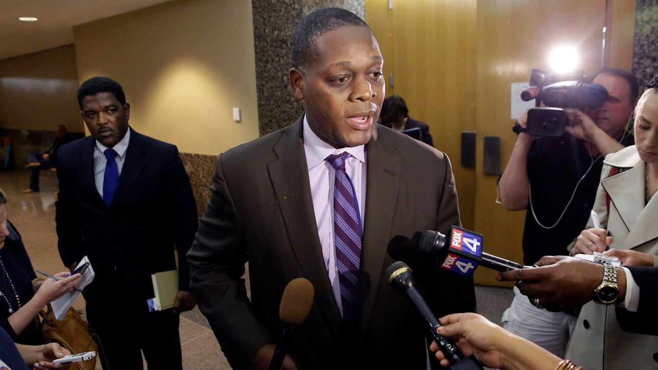 Dallas District attorney Craig Watkins speaks to reporters after a court hearing setting the probation conditions for Sir Young in Dallas Thursday, May 8, 2014.  (AP Photo/LM Otero)