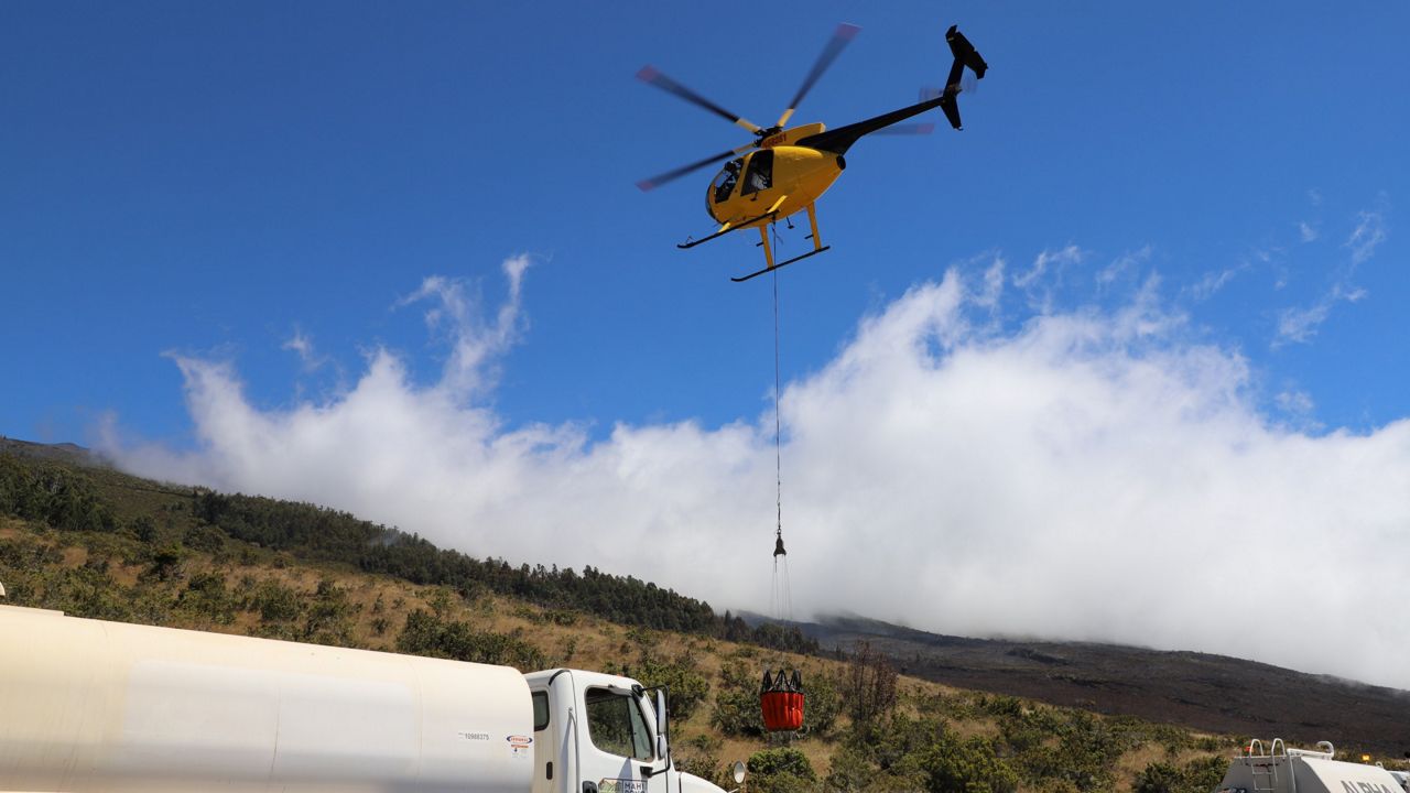 Four engines, three wildland engines, 11 tankers, five dozers and two helicopters are active, and that the fire is located at the 7,000-foot elevation. (Photo courtesy DLNR)