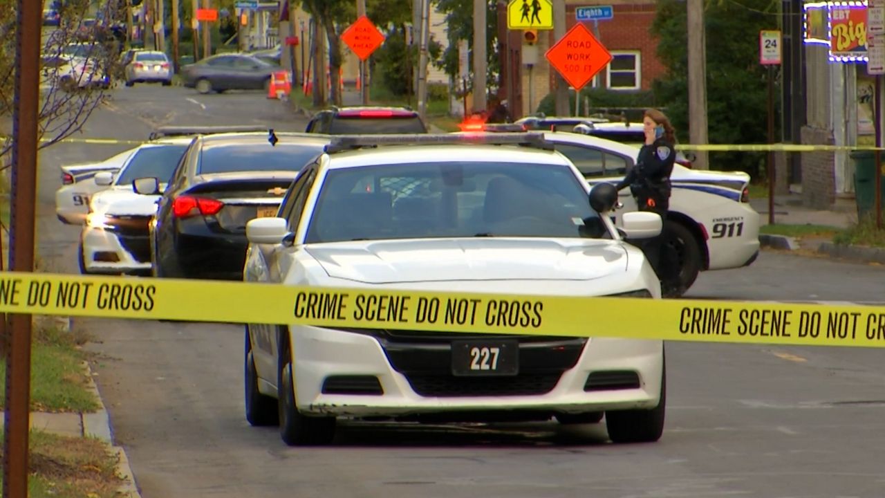 A crime scene in Rochester with police tape and cruisers 