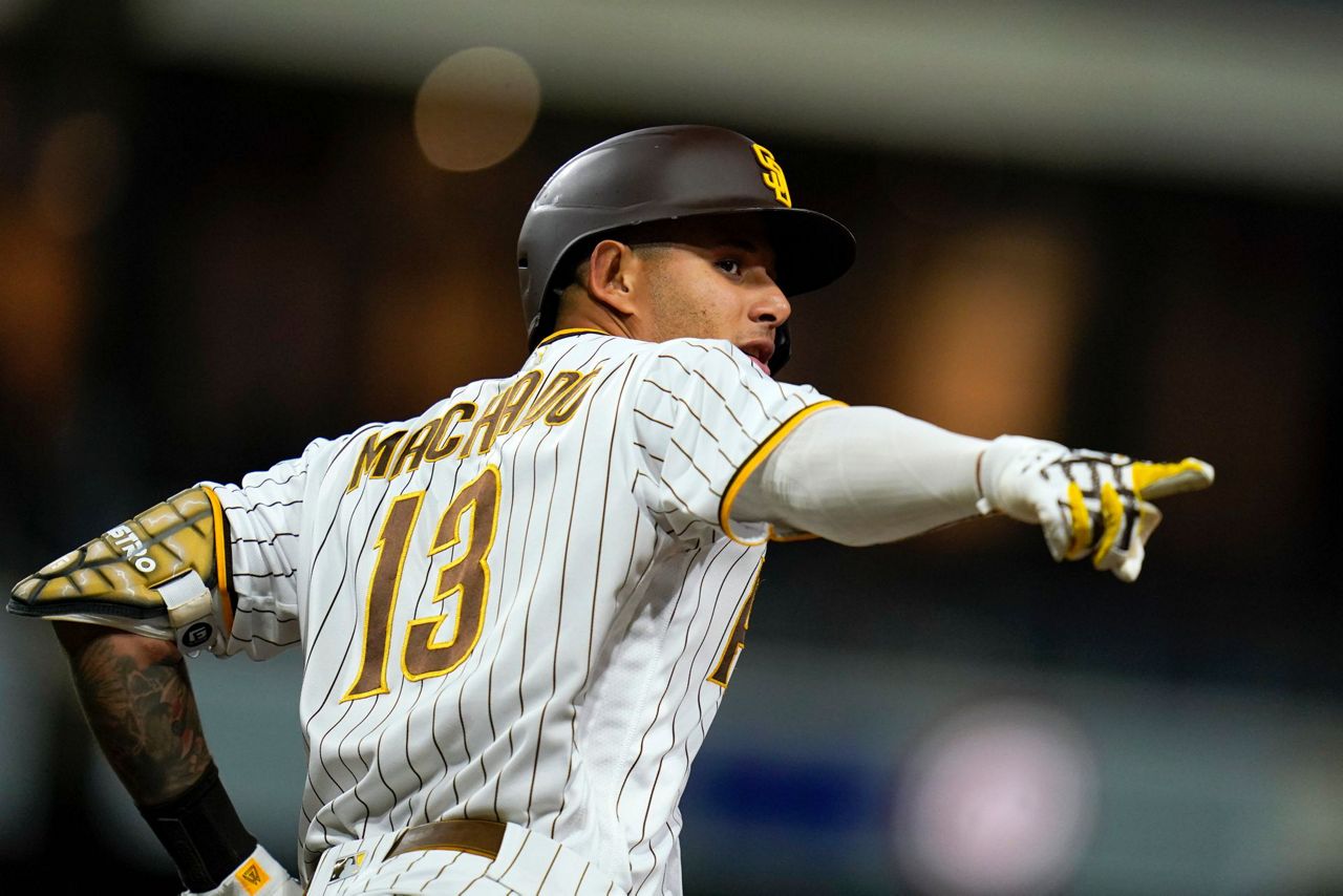 San Diego Padres third baseman Manny Machado, right, walks on the