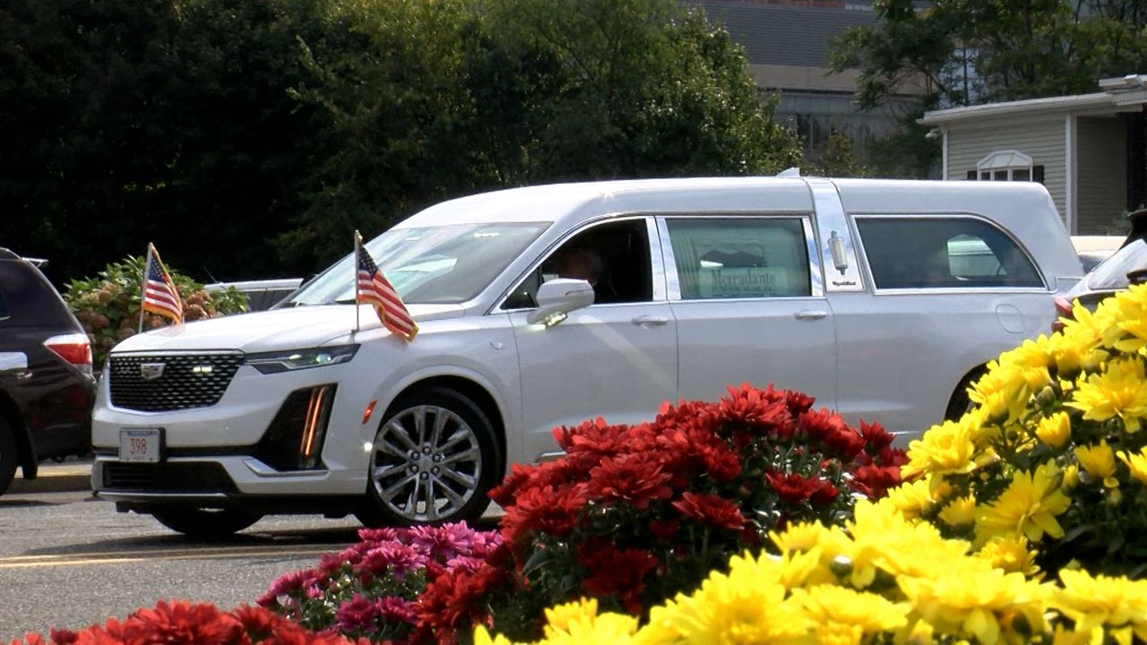 A hearse carrying the body of Enrique Delgado-Garcia departs Mercadante Funeral Home & Chapel on Saturday. (Spectrum News 1/Devin Bates)