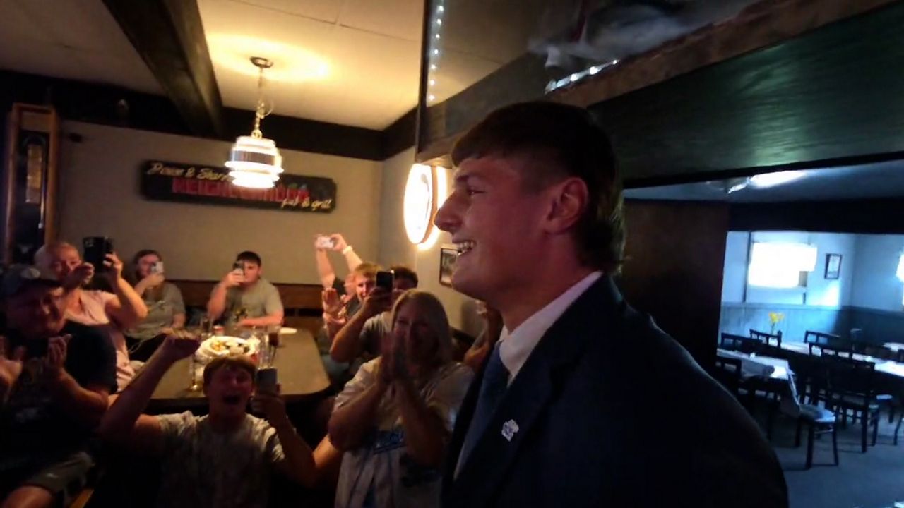 (Alex Breckheimer smiling while getting drafted)