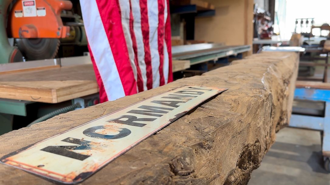 This piece of wood is one of many reclaimed from a barn near Omaha Beach in France. (Spectrum News)
