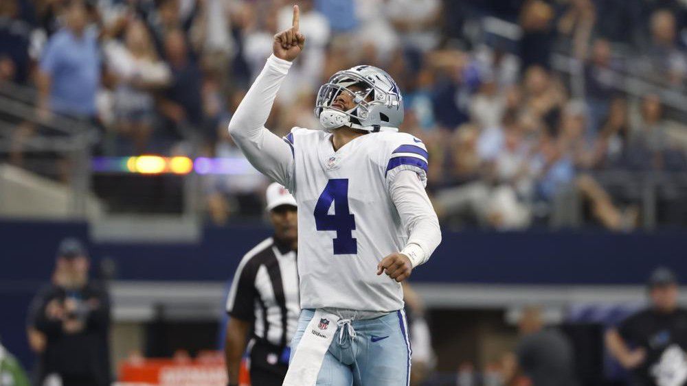 Dallas Cowboys quarterback Dak Prescott (4) celebrates after throwing a touchdown pass to tight end Blake Jarwin in the first half of a NFL football game against the Carolina Panthers in Arlington, Texas, Sunday, Oct. 3, 2021. (AP Photo/Ron Jenkins)
