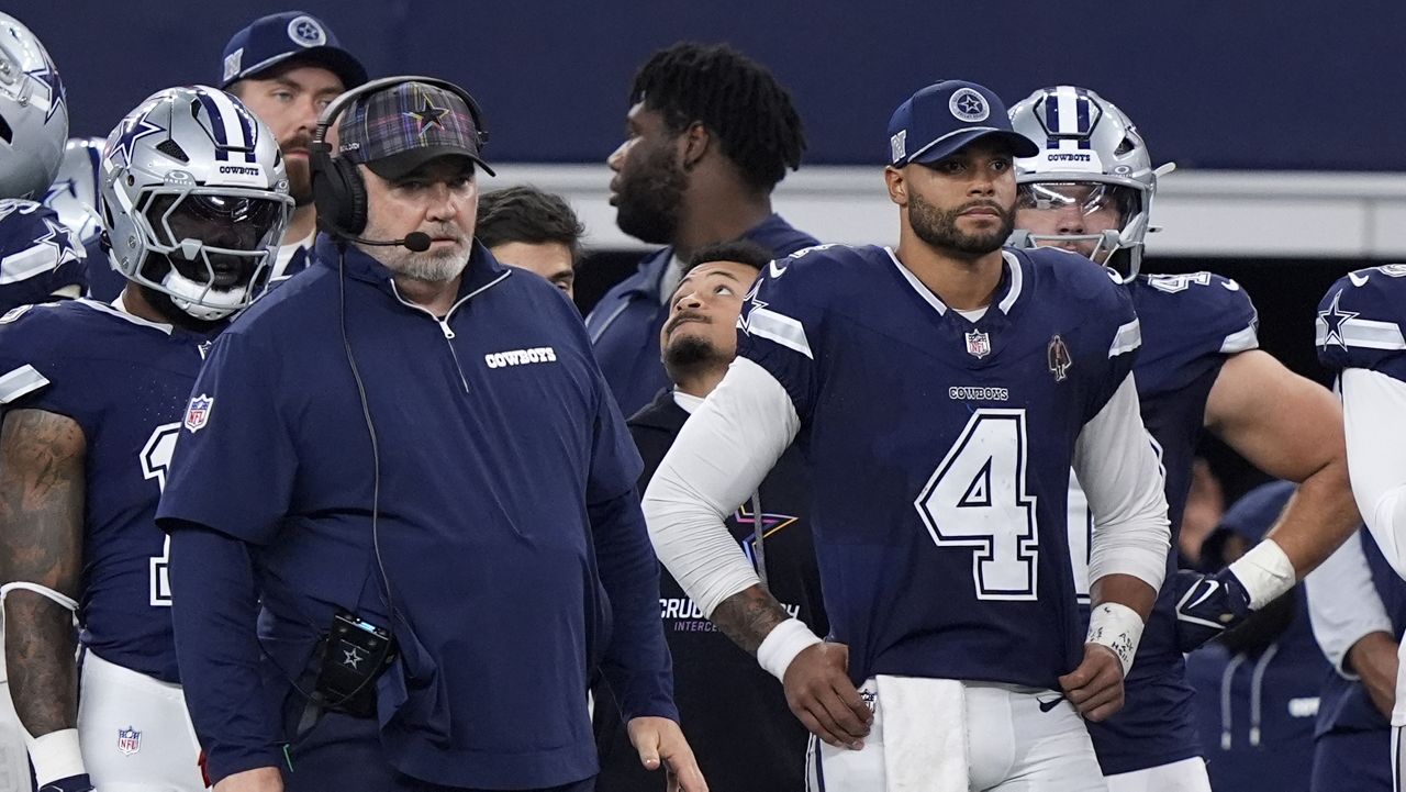 Dallas Cowboys head coach Mike McCarthy, left, and quarterback Dak Prescott (4) watch play against the Detroit Lions in the second half of an NFL football game in Arlington, Texas, Sunday, Oct. 13, 2024. (AP Photo/LM Otero)