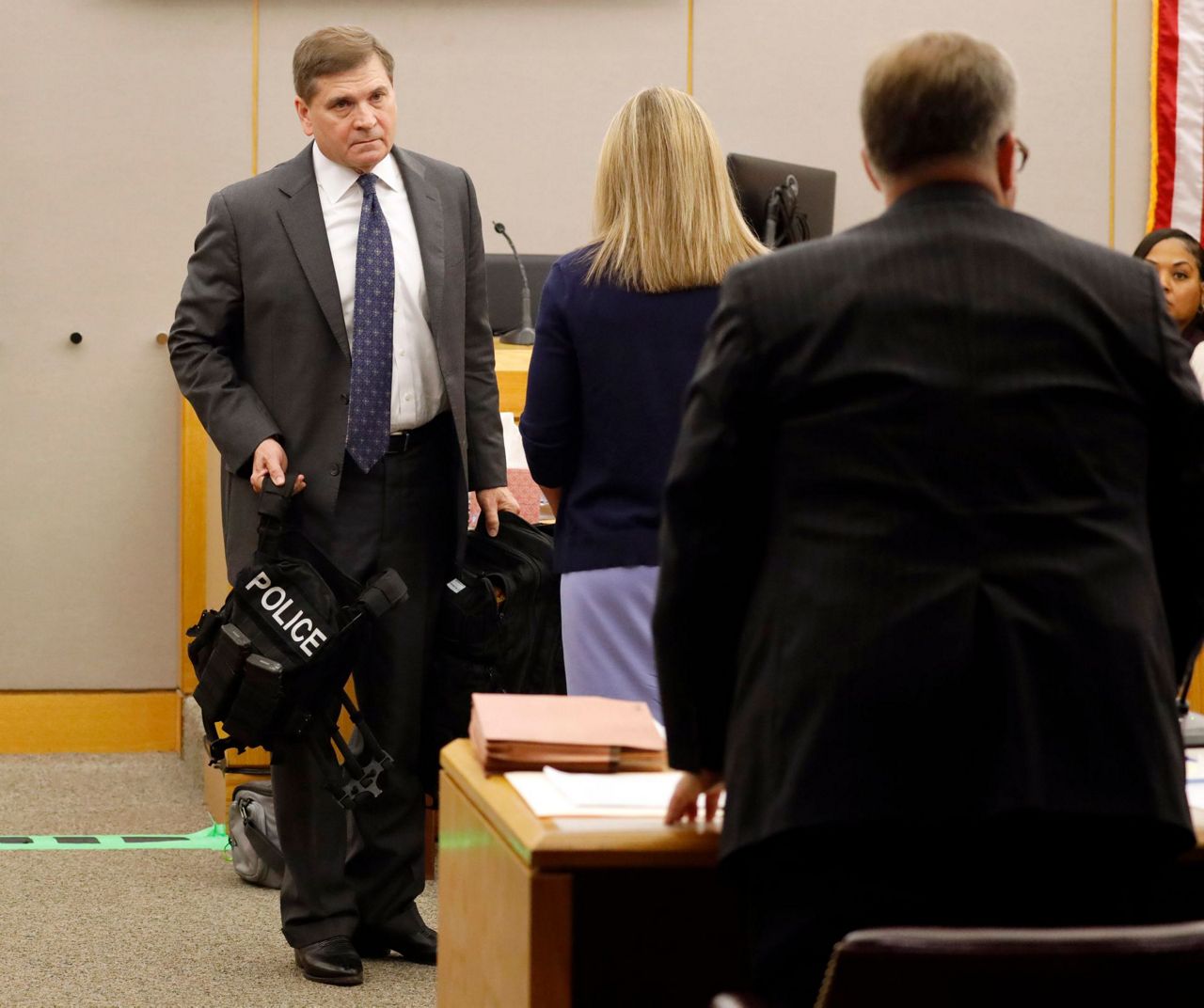 The Latest: Officer cries recalling night she shot neighbor