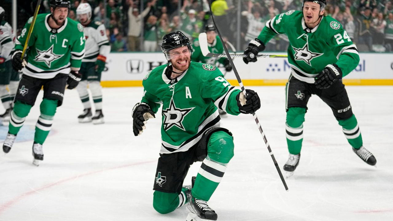 Dallas Stars center Tyler Seguin (91) celebrates with Jamie Benn, left, and Roope Hintz (24) after scoring against the Minnesota Wild during the first period of Game 5 of an NHL hockey Stanley Cup first-round playoff series Tuesday, April 25, 2023, in Dallas. (AP Photo/Tony Gutierrez)