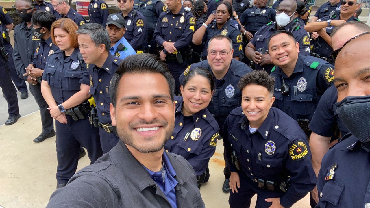 Pictured is Spectrum News 1 Texas human interest reporter Lupe Zapata and members of the Dallas Police Department before the Dallas Pride flag was raised at a June 1 flag raising ceremony at Dallas Police Department headquarters. (Spectrum News 1/Lupe Zapata)