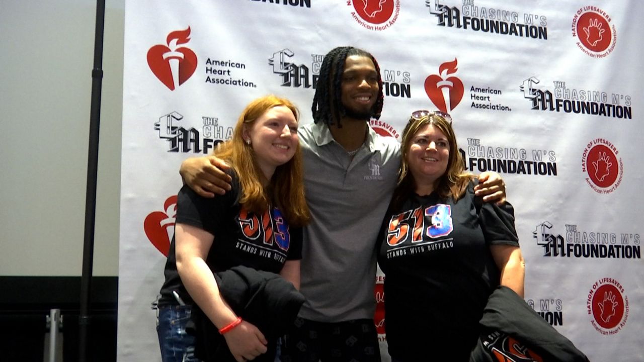 Damar Hamlin poses with a few fans at an event in Cincinnati in July where he passed out AEDs and taught the community CPR.