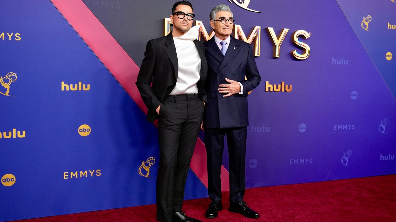 Dan Levy, left, and Eugene Levy arrive at the 76th Primetime Emmy Awards on Sunday, Sept. 15, 2024, at the Peacock Theater in Los Angeles. (AP Photo/Jae C. Hong)