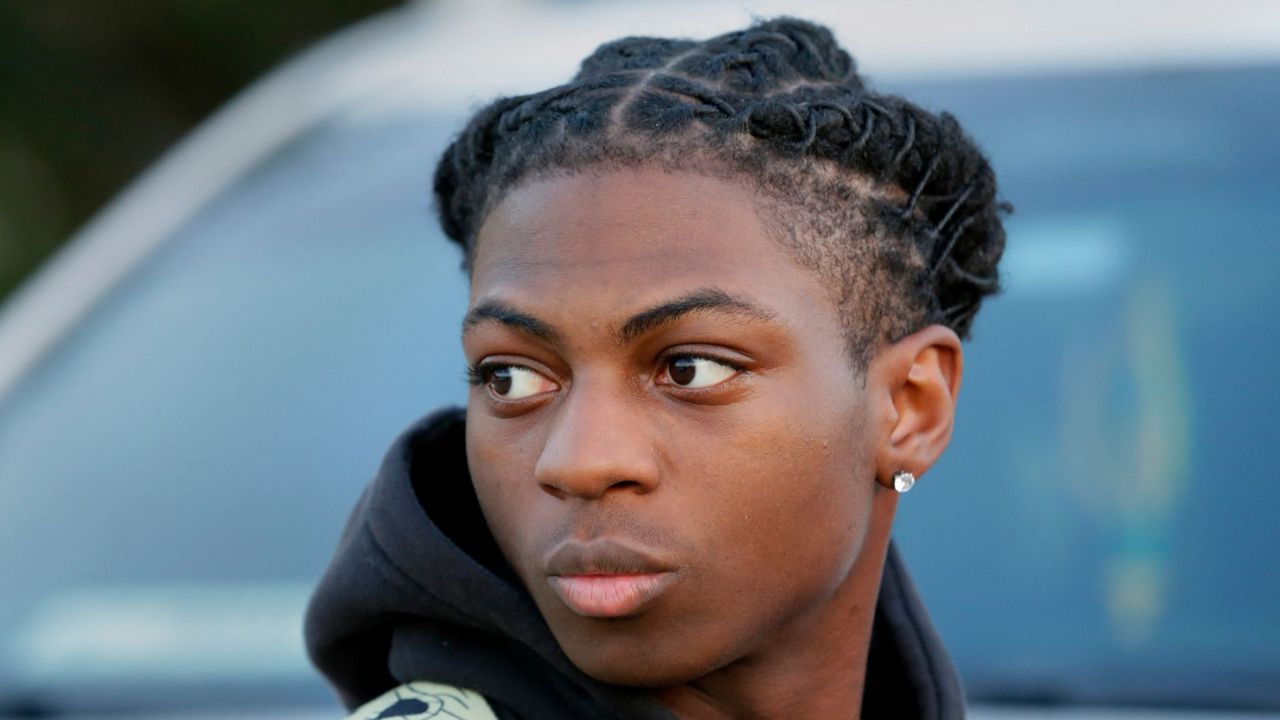 Darryl George, an 18-year-old junior, looks on before walking into Barbers Hill High School after serving an in-school suspension for not cutting his hair, Sept. 18, 2023, in Mont Belvieu, Texas. The Texas high school Black student who has been disciplined and kept away from his classroom for months for refusing to change his hairstyle is not likely to be back with his regular classmates anytime soon. (AP Photo/Michael Wyke, File)