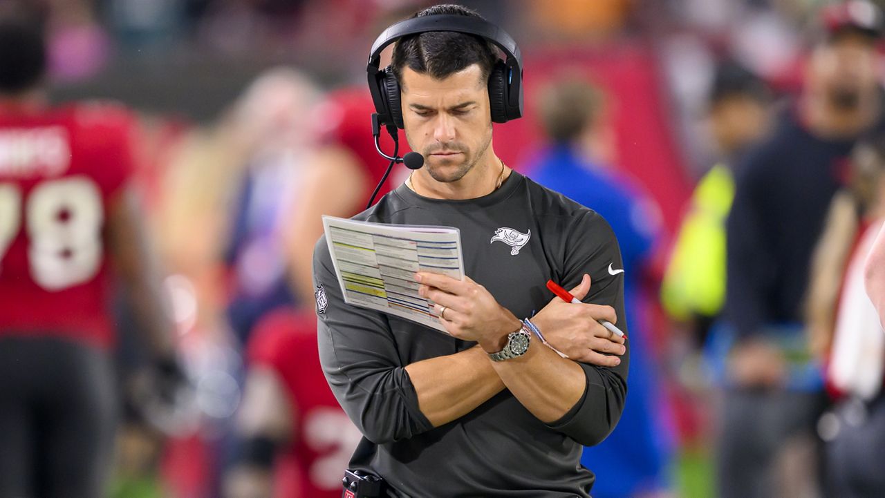 Tampa Bay Buccaneers offensive coordinator Dave Canales reviews the play sheet on the sidelines during an NFL wild-card playoff football game against the Philadelphia Eagles, Monday, Jan. 15, 2024 in Tampa, Fla. (AP Photo/Doug Murray)