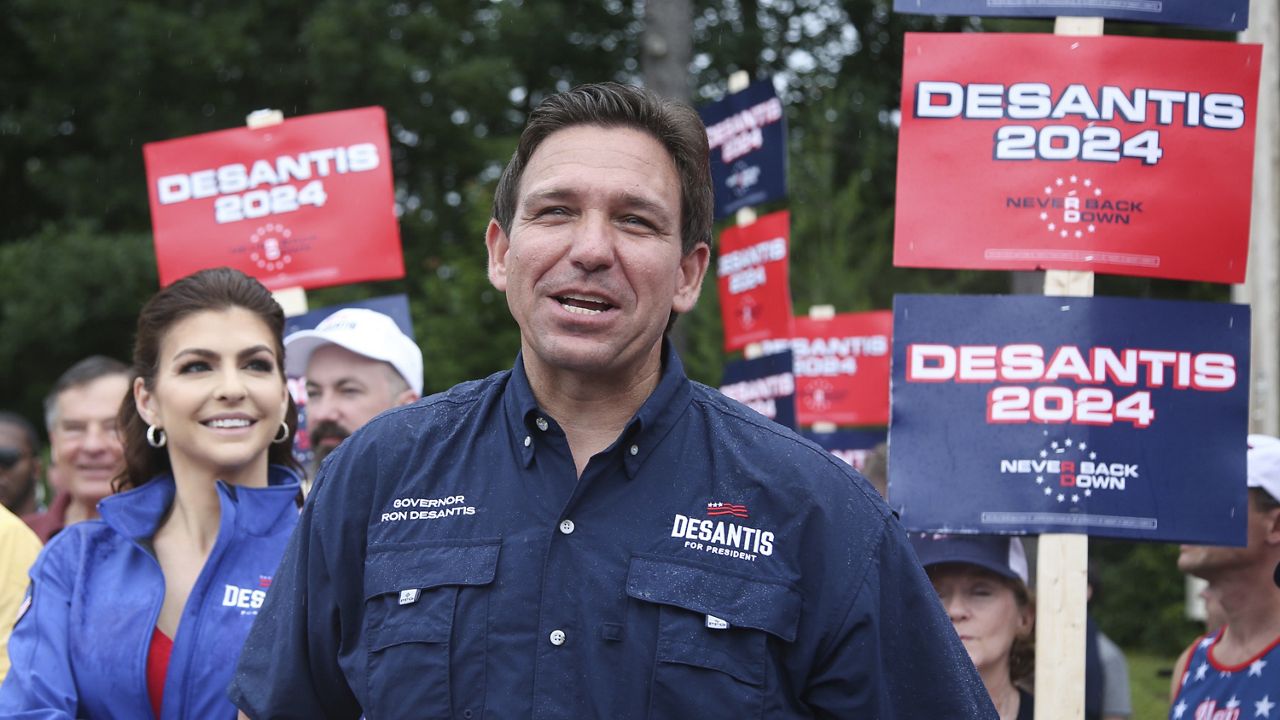 Republican presidential candidate and Florida Gov. Ron DeSantis and his wife Casey, walk in the July 4th parade, July 4, 2023, in Merrimack, N.H. (AP Photo/Reba Saldanha