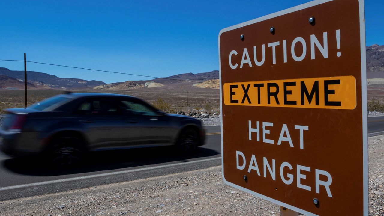 A sign stands warning of extreme heat Tuesday, July 11, 2023, in Death Valley National Park, Calif. July is the hottest month at the park with an average high of 116 degrees (46.5 Celsius). (AP Photo/Ty ONeil)