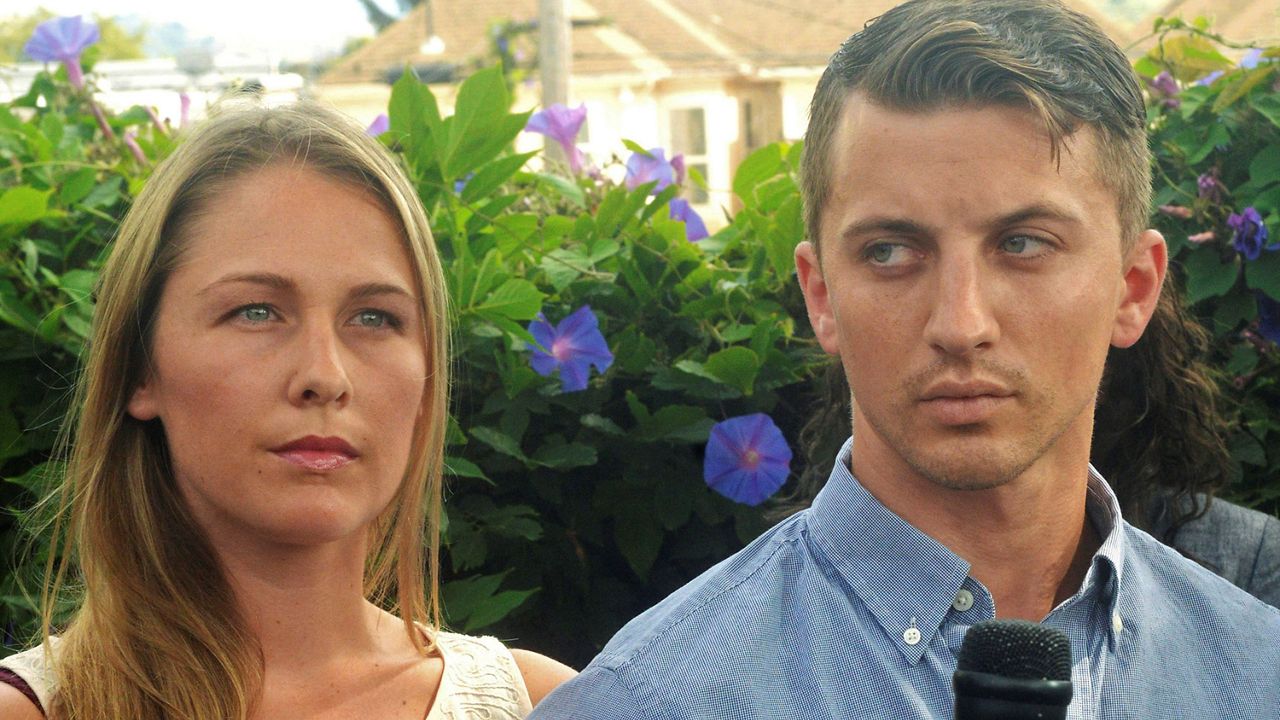 Denise Huskins, left, and her boyfriend, Aaron Quinn listen as their attorneys speak at a news conference on July 13, 2015, in Vallejo, Calif. (Mike Jory/The Times-Herald via AP, File)