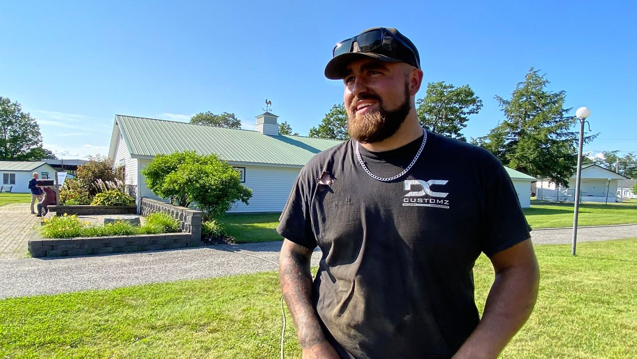 Palermo resident Denver Cullivan talks about his concerns with the Aroostook Renewable Gateway project on Thursday at the Windsor Fairgrounds. (Spectrum News/Susan Cover)