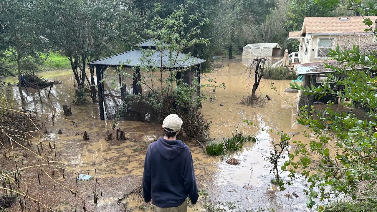 Dervaux overlooking the damage to her home after heavy storms swept through in January 2023. (Nathalie Dervaux)