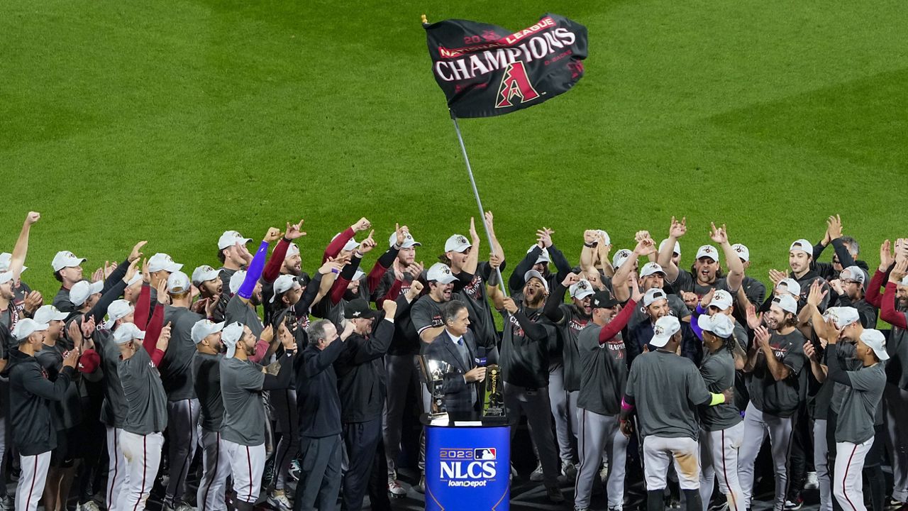 Members of the Tampa Bay Rays hold up the American League Championship  Trophy after defeating the Boston Red Sox 3-1 to win the Championship at  Tropicana Field in St. Petersburg, Florida on