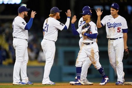 Former Los Angeles Dodgers pitcher Fernando Valenzuela, center, greets his  family as he is honored before a baseball game between the Arizona  Diamondbacks and the Los Angeles Dodgers Wednesday, Sept. 15, 2021