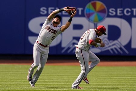 Arizona Diamondbacks left fielder David Peralta (6), second baseman Ketel  Marte (12), and center fielder Jake McCarthy (30) celebrate after closing  the ninth inning of a baseball game against the New York