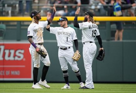 Raimel Tapia of the Colorado Rockies loses his helmet while