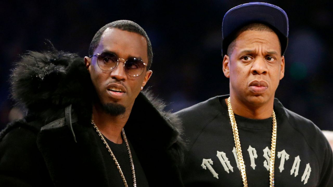 Rap moguls Sean "Diddy" Combs, left, and Jay-Z attend the NBA All-Star basketball game, Feb. 15, 2015, in New York. (AP Photo/Kathy Willens, File)