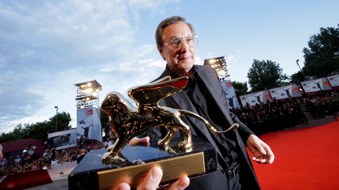 Director William Friedkin holds an award at the Venice Film Festival.