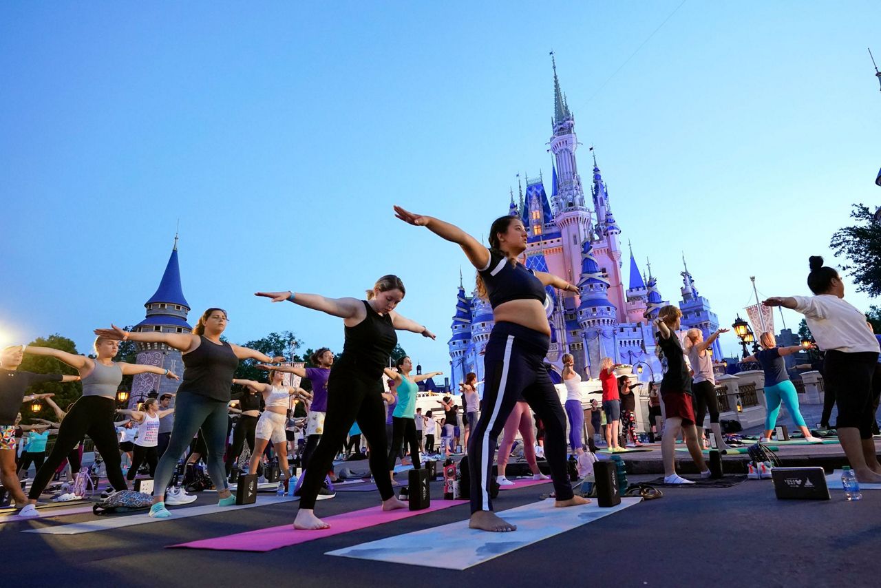 Disney workers trade costumes for yoga pants on Yoga Day