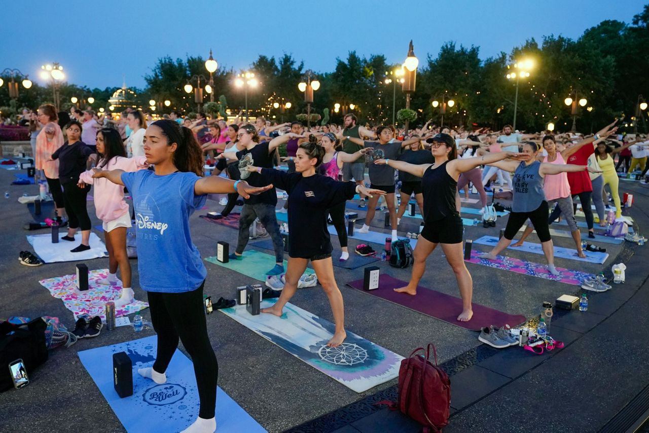 Disney workers trade costumes for yoga pants on Yoga Day