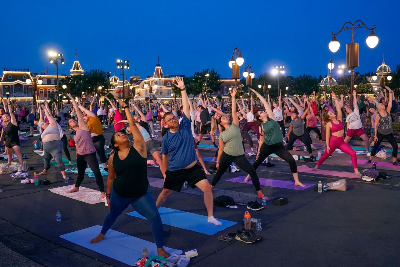 Disney workers trade costumes for yoga pants on Yoga Day
