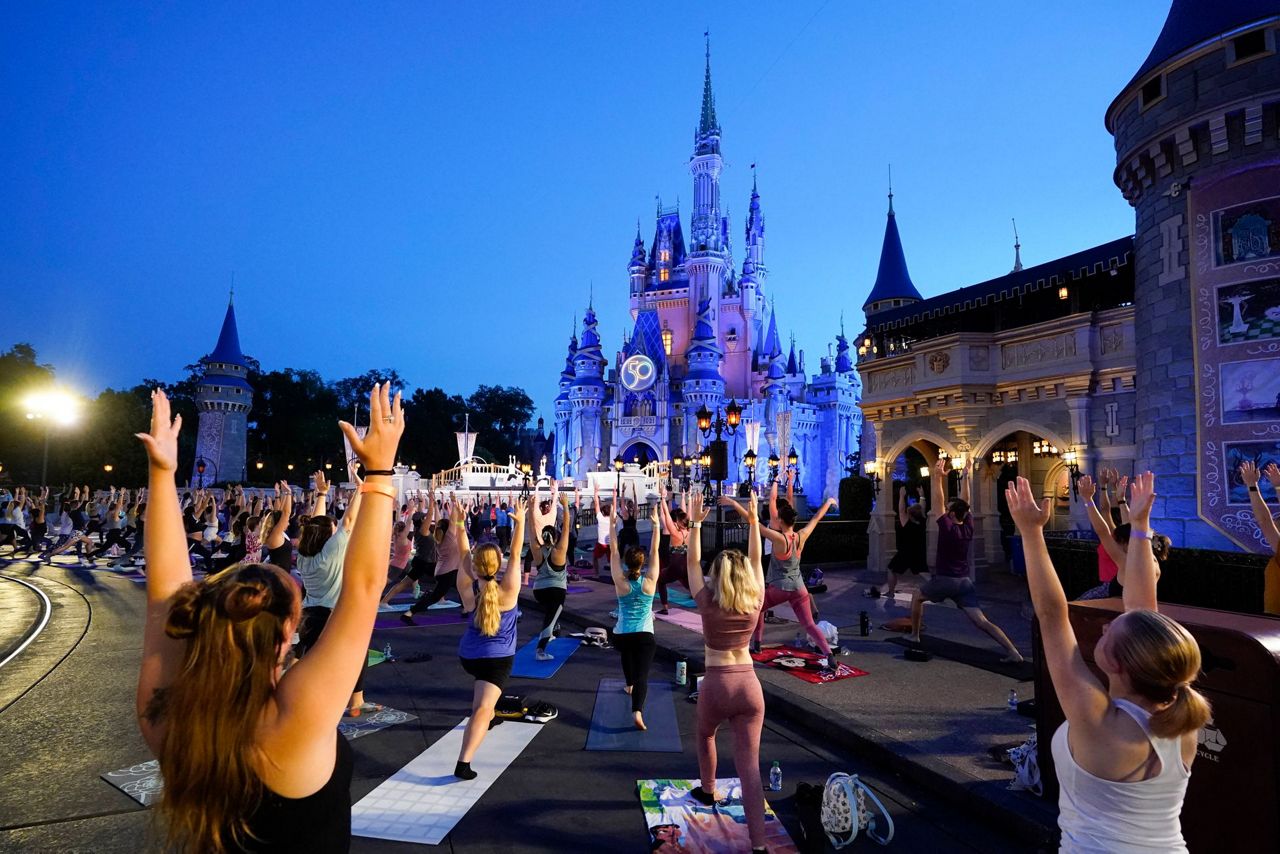 Disney workers trade costumes for yoga pants on Yoga Day