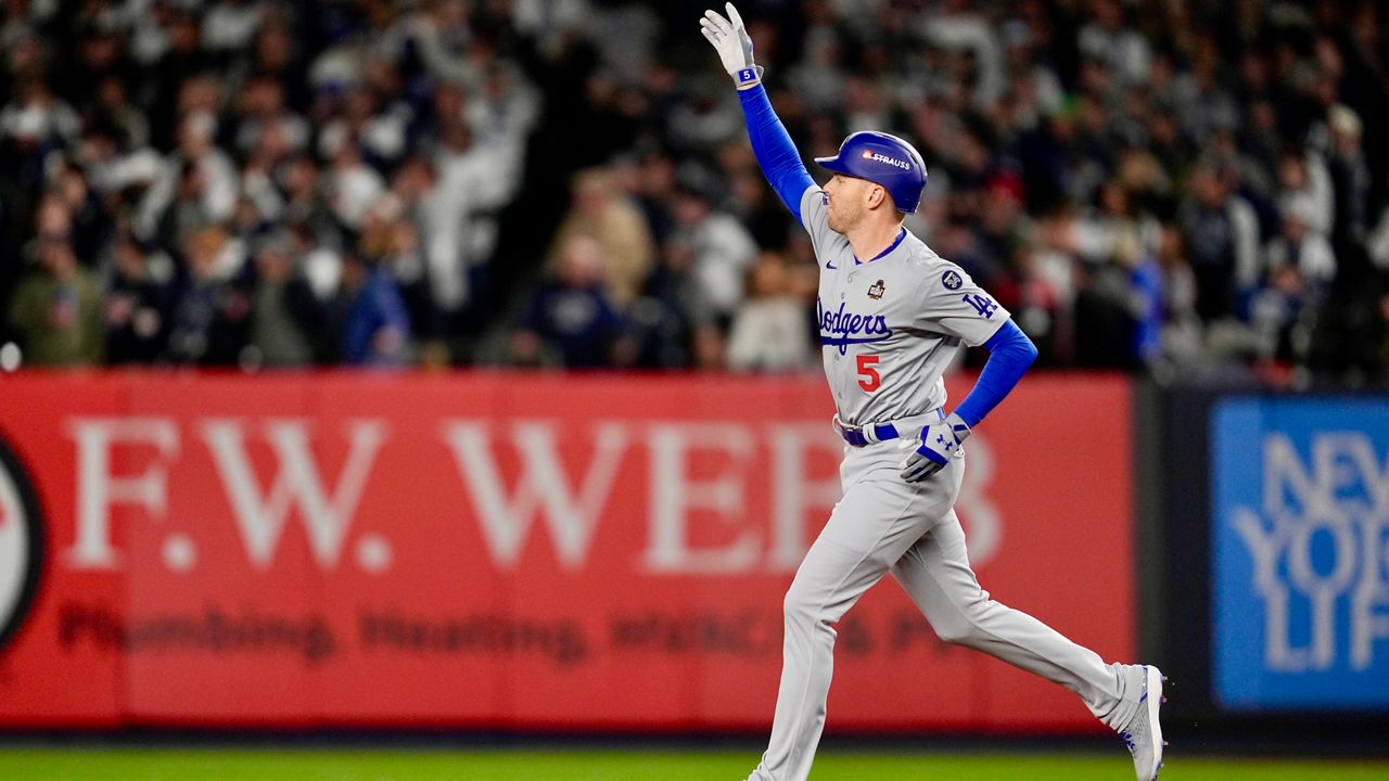 Los Angeles Dodgers' Freddie Freeman hits a two-run home run against the New York Yankees during the first inning in Game 3 of the baseball World Series, Monday, Oct. 28, 2024, in New York. (AP Photo/Frank Franklin II)