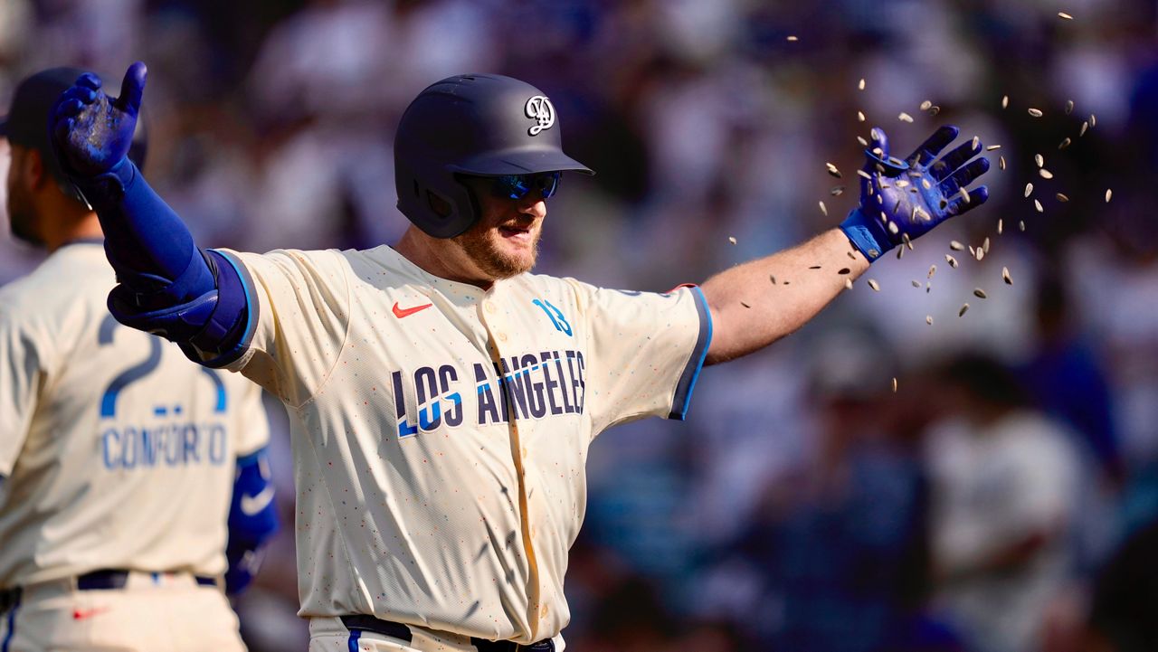 Los Angeles Dodgers' Max Muncy has seeds thrown at him after hitting a three-run home run during the second inning of a baseball game against the New York Yankees, Saturday, May 31, 2025, in Los Angeles. (AP Photo/Mark J. Terrill)