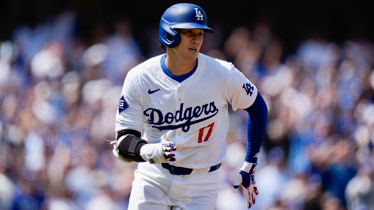 Los Angeles Dodgers' Shohei Ohtani runs to first base after hitting a double against the St. Louis Cardinals during the first inning of a baseball game Thursday, March 28, 2024, in Los Angeles. (AP Photo/Jae C. Hong)