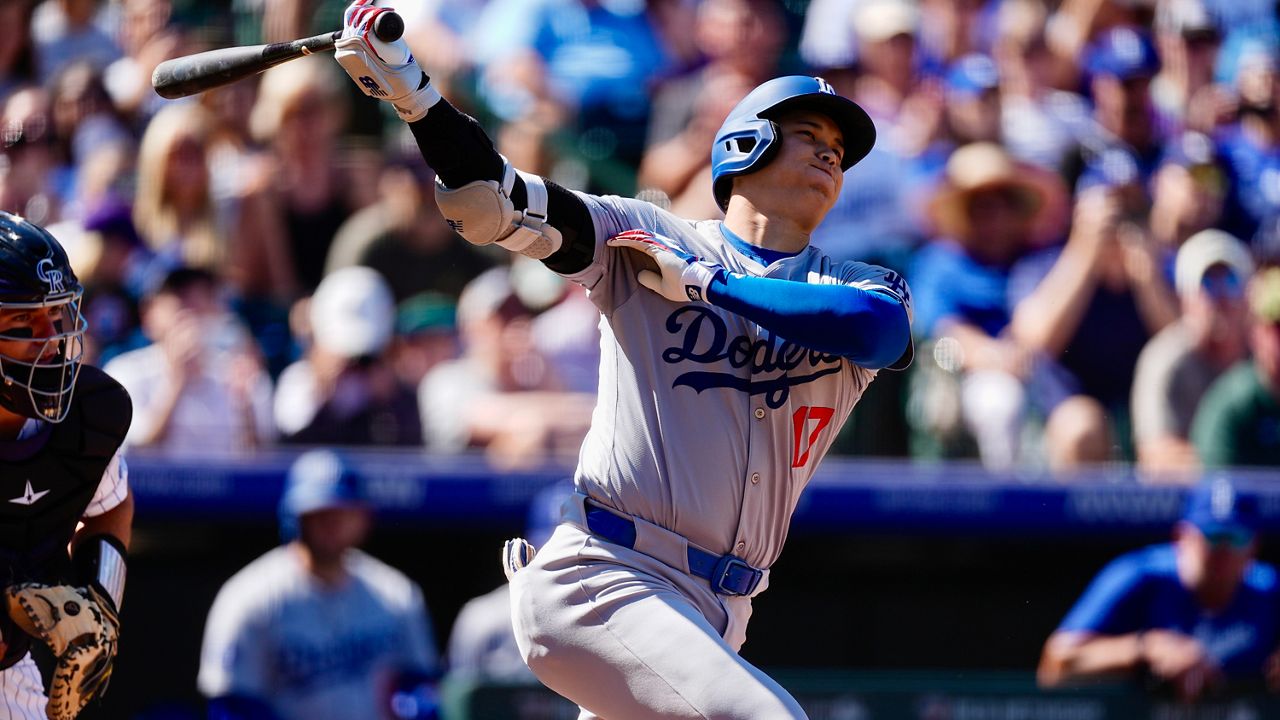 Los Angeles Dodgers' Shohei Ohtani grounds out against Colorado Rockies starting pitcher Ryan Feltner in the first inning of a baseball game Sunday, Sept. 29, 2024, in Denver. (AP Photo/David Zalubowski)