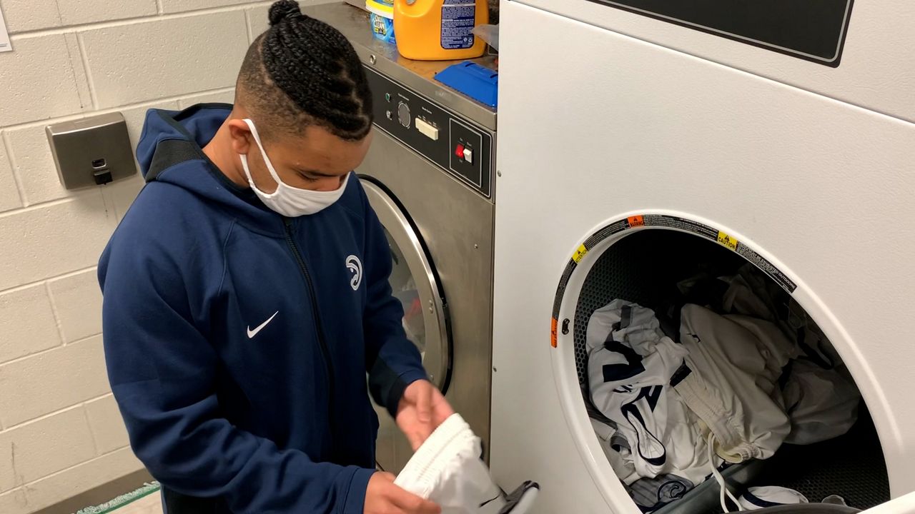 Donavon Greene does laundry (Adam Rossow/Spectrum News 1)