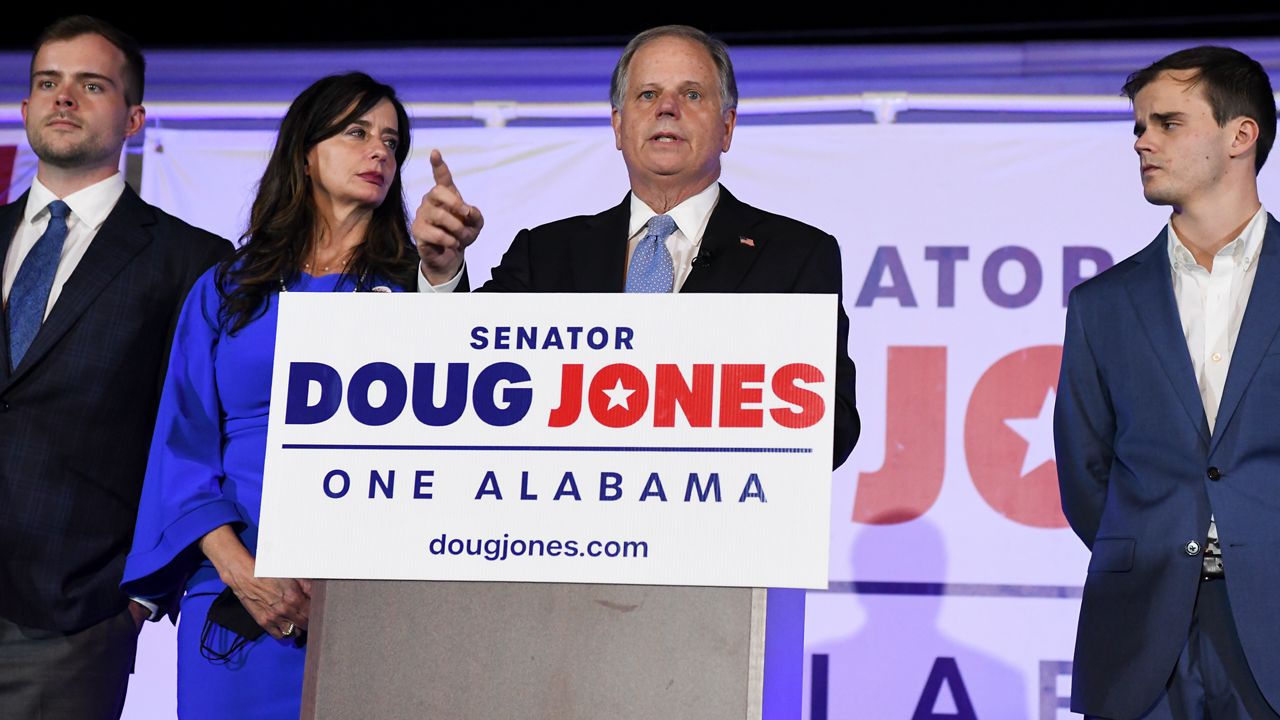Sen. Doug Jones delivers his concession speech surrounded by family during his election night watch party, Tuesday, Nov. 3, 2020, in Birmingham, Ala. Jones lost his seat to Republican Tommy Tuberville. (AP Photo/Julie Bennett)