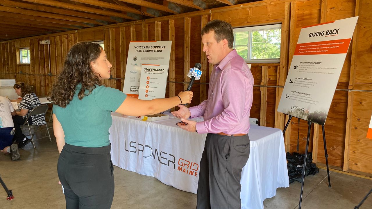 LS Power vice-president Doug Mulvey speaks to a television reporter Thursday during an open house about a new proposed power line designed to connect a wind farm in Aroostook County to the regional grid in Windsor. (Spectrum News/Susan Cover)