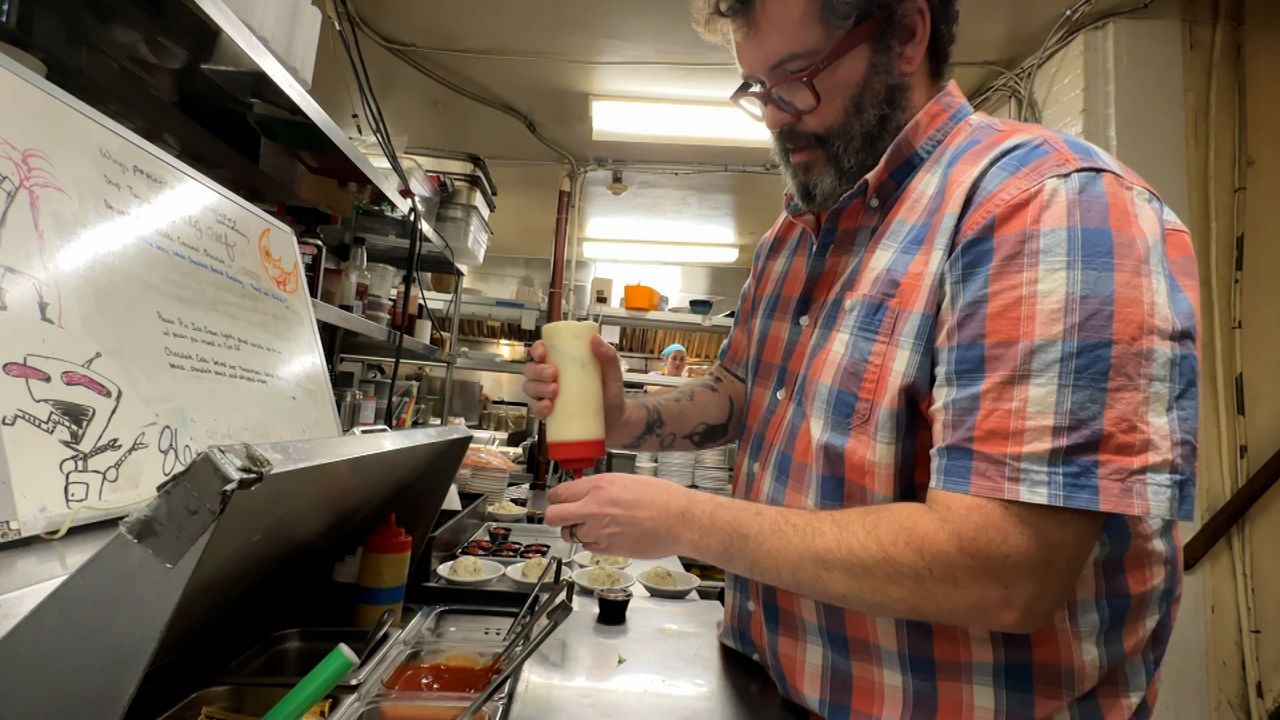 Owner Dan Breeden helps out in the kitchen during the lunch rush.