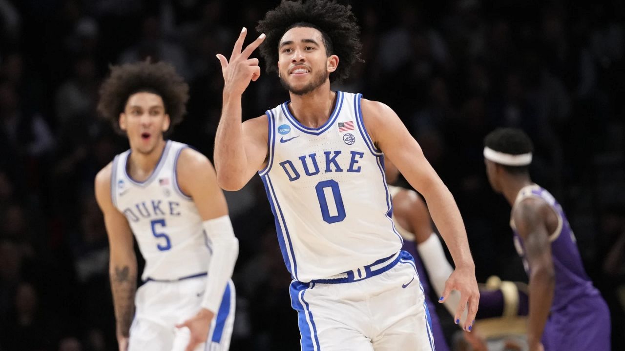 Duke guard Jared McCain (0) and guard Tyrese Proctor (5) reacts after McCain scored a 3-point basket during the first half of a second-round college basketball game against James Madison in the NCAA Tournament, Sunday, March 24, 2024, in New York. (AP Photo/Mary Altaffer)