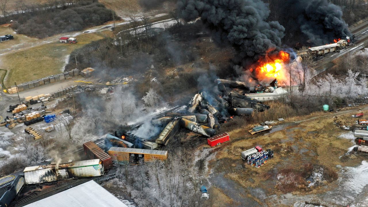 In this photo taken with a drone, portions of a Norfolk Southern freight train that derailed the previous night in East Palestine, Ohio, remain on fire at mid-day, Feb. 4, 2023. (AP Photo/Gene J. Puskar, File)