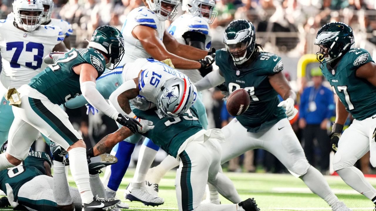 Dallas Cowboys running back Ezekiel Elliott (15) fumbles the ball as he's hit by Philadelphia Eagles linebacker Zack Baun (53) in the first half of an NFL football game in Arlington, Texas, Sunday, Nov. 10, 2024. (AP Photo/Jeffrey McWhorter)