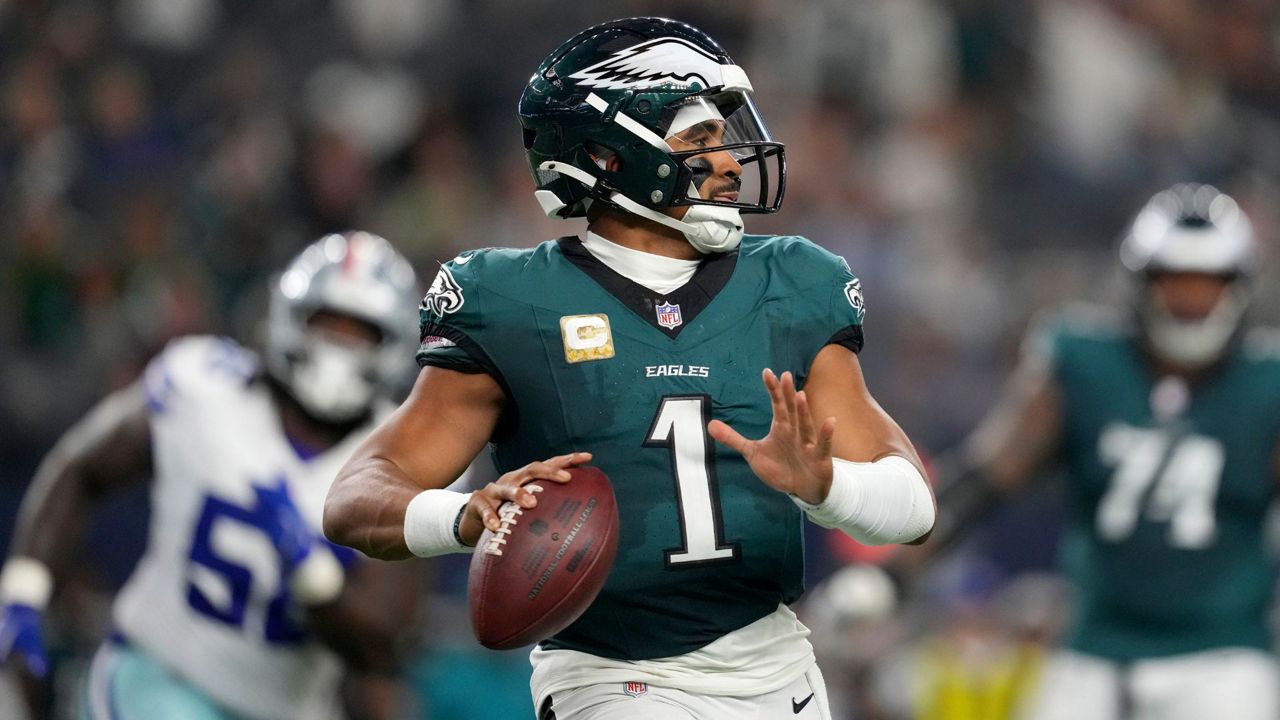 Jalen Hurts looks for an open man downfield against the Cowboys