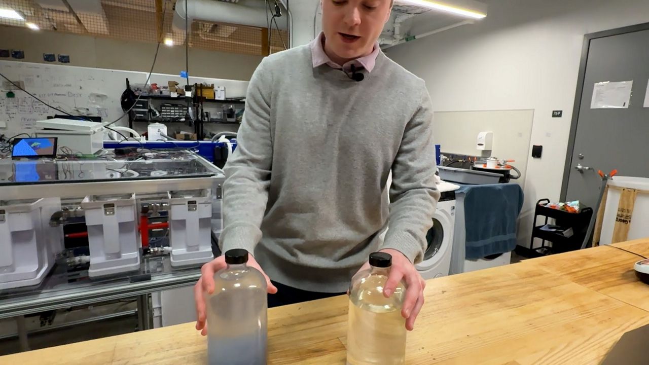 CLEANR COO and co-founder Chip Miller shows the difference in water collected from a normal washing machine and one with the CLEANR microplastic filter.